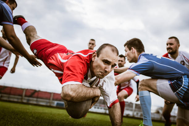 istock Determined rugby player jumping to score a touchdown on a match. 2195029331