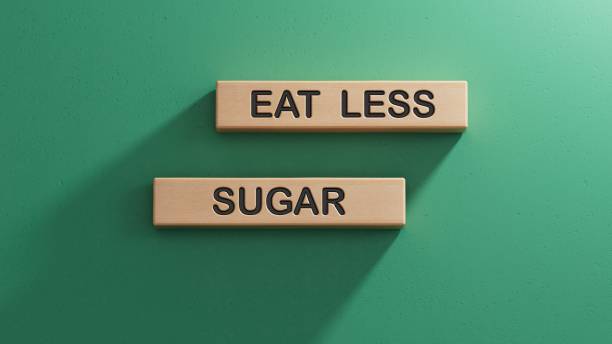 istock eat less sugar words on notebook and stethoscope on wooden cubes. Wooden cube blocks. Copy space.3D rendering on green background. 2195030648
