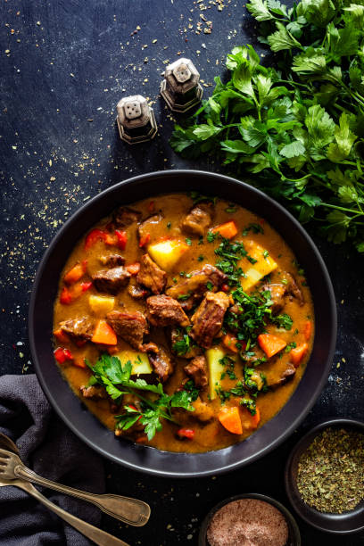 istock Beef stew with vegetables and potatoes on black table 2195035321
