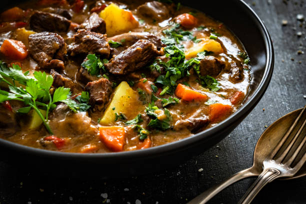 istock Beef stew with vegetables and potatoes on black table 2195035427