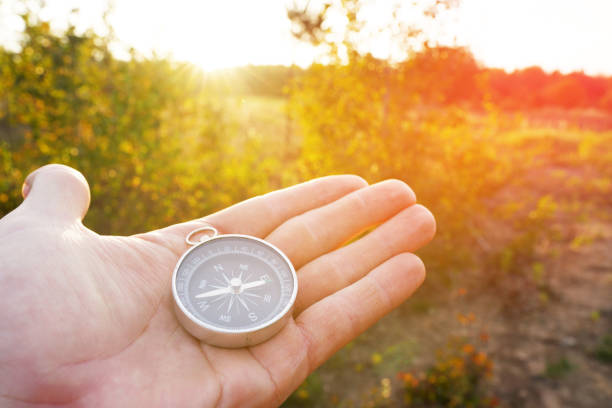 istock Compass in hand at forest. Tourist compass for orientation on the terrain. 2195035891