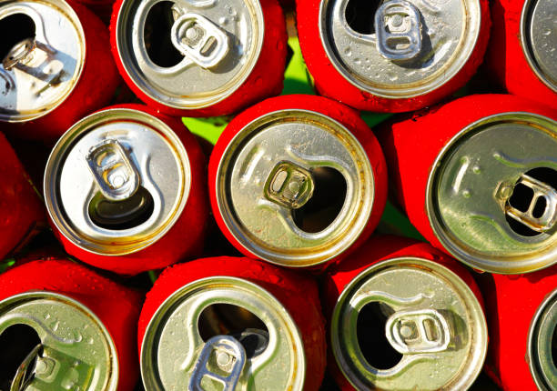 istock Opened Coke Cans background, texture. Open drink soda cans close up, top view. 2195036493