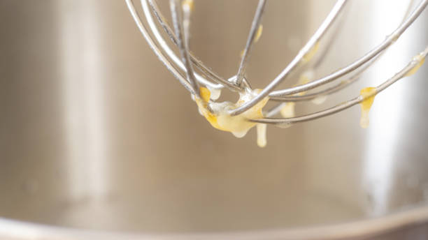 istock Beating eggs with an electric mixer close up. 2195038976