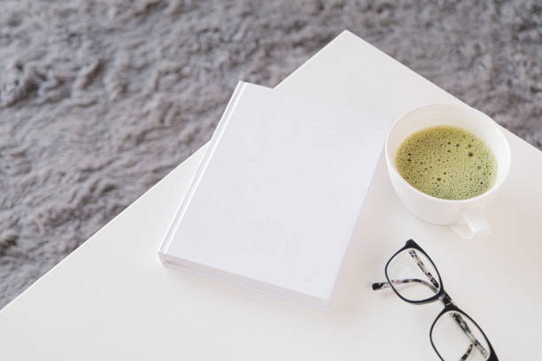 istock blank book mockup on white coffee table with green matcha tea near window 2195039533