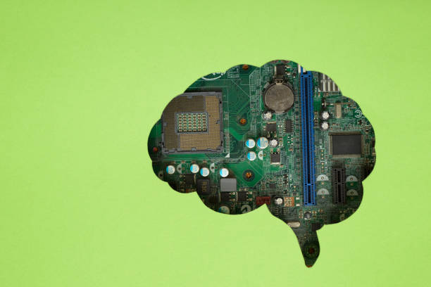 istock Green sheet of paper with brain-shaped hole revealing a computer motherboard. Technology concept. 2195041336