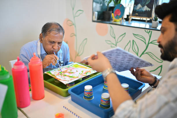 istock Senior man crafting fluid art with a straw technique 2195041645