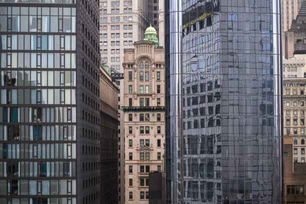 istock Old skyscraper between new modern glass high rise towers in Lower Manhattan 2195042340