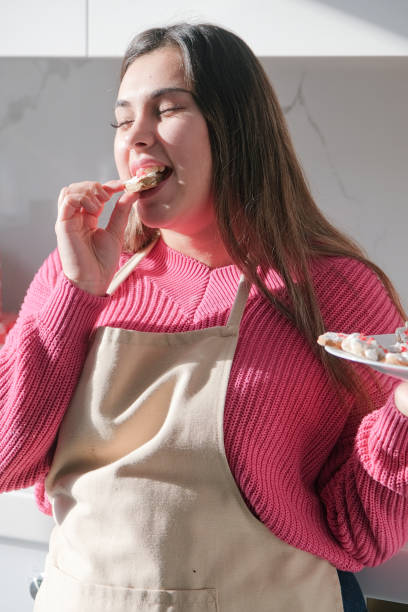 istock woman making heart shaped cookies in the kitchen 2195043504