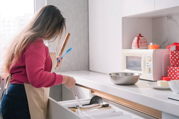 istock brunette woman cooking in the kitchen 2195044143