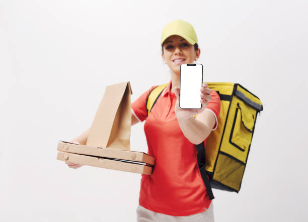 istock Delivery girl holding a smartphone 2195044517