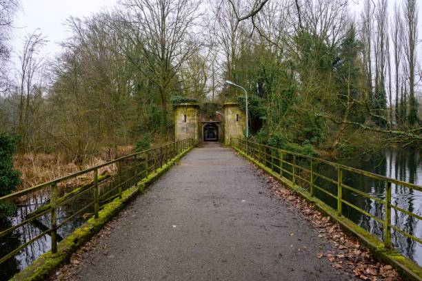 istock Tranquil park pathway leading to an archway. 2195045417