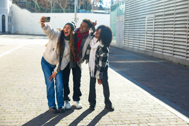 istock Three happy friends taking a selfie on a sunny winter day 2195046190