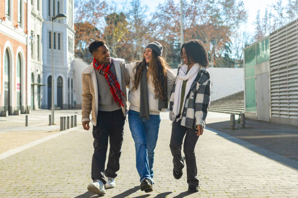 istock Happy multi ethnic students walking together on campus during winter break 2195046208