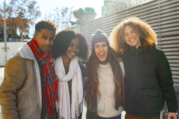 istock Group of students smiling together outdoors in winter clothes 2195046224