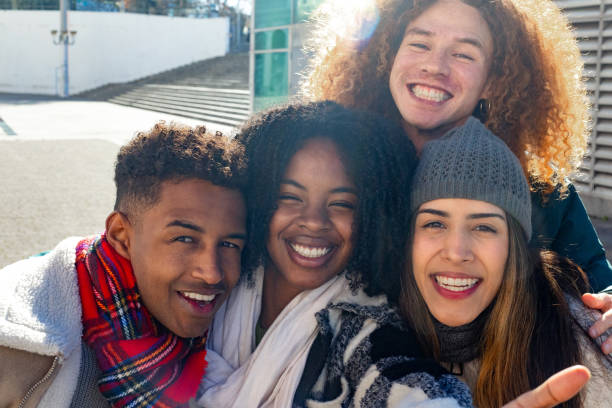 istock Happy multi ethnic students smiling together outdoors in winter clothes 2195046226