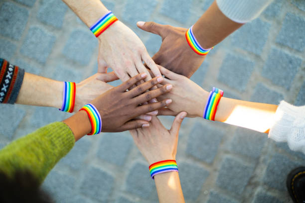 istock Activists showing support for lgbt community with rainbow bracelets 2195046307