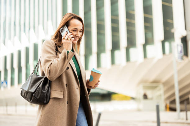 istock Woman coming back from work and telephoning 2195047005