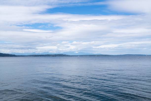 istock Ocean view with distant coastline and cloudy sky. 2195047132