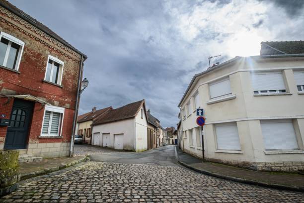 istock Charming French street with cobblestones under a cloudy sky 2195048477