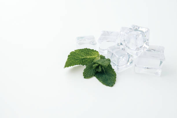 istock Fresh mint leaves and clear ice cubes on a white background. A minimalistic composition emphasizing freshness and simplicity, perfect for concepts related to beverages, cooling, or summer 2195049707