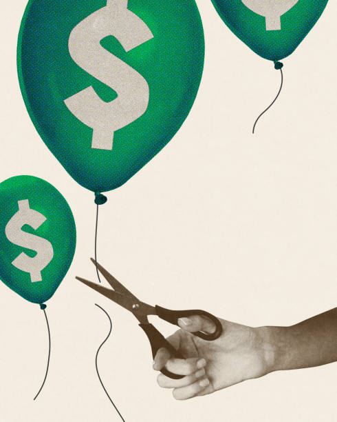 istock Hand cutting strings of dollar-symbol balloons with scissors, symbolizing deflation and financial cuts. Conceptual creative design. 2195049866