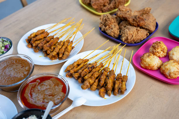 Malaysian fried chicken and chicken satay with delicious peanut sauce, one of famous local dishes.
