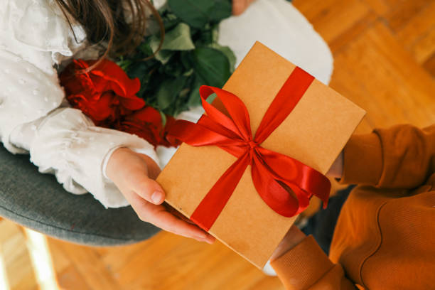 istock Holiday concept, people give a gift in their hands, top view 2195049977