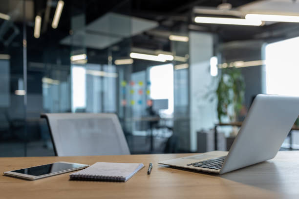 istock Modern office desk setup with laptop, smartphone, and notebook in sleek environment 2195050152
