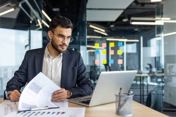istock Mature man businessman working on documents at a desk in modern office 2195050175