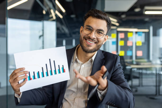 istock Latin American businessman presenting financial data in modern office environment 2195050183