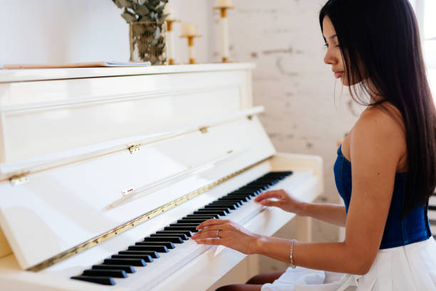 istock A girl playing the piano 2195051688