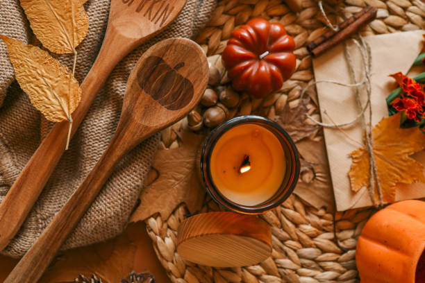 istock Burning candle in a cozy warm homey autumn atmosphere 2195053046