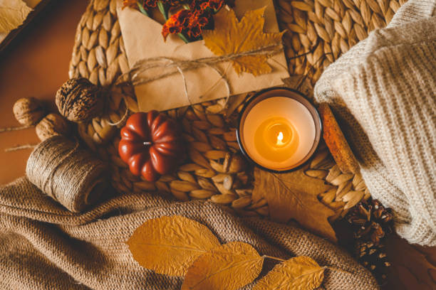 istock Burning candle in a cozy warm homey autumn atmosphere 2195053076