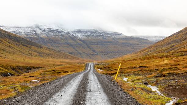 istock Remote gravel road in autumn valley. 2195053266