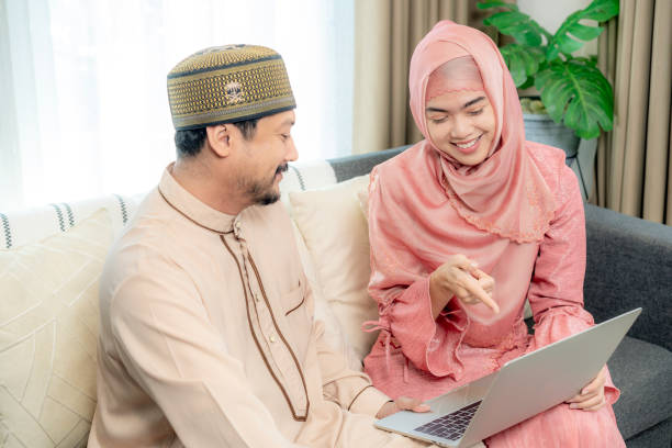 istock A young couple happily using a laptop together at home 2195055405
