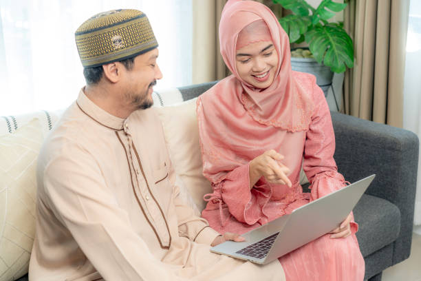 istock A young couple happily using a laptop together at home 2195055410