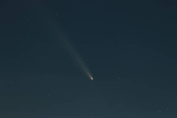 istock Clear night sky showcasing a bright comet with a visible tail among scattered stars. 2195056115
