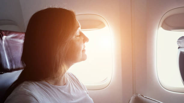 istock Woman relaxing looking out airplane window 2195056869