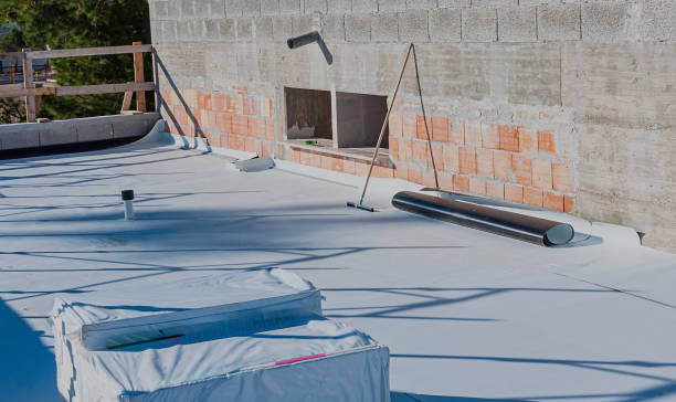 istock Construction site with a flat roof being waterproofed. The image shows a partially installed waterproof membrane, tools, and construction materials. The scene highlights the roofing process. 2195058898