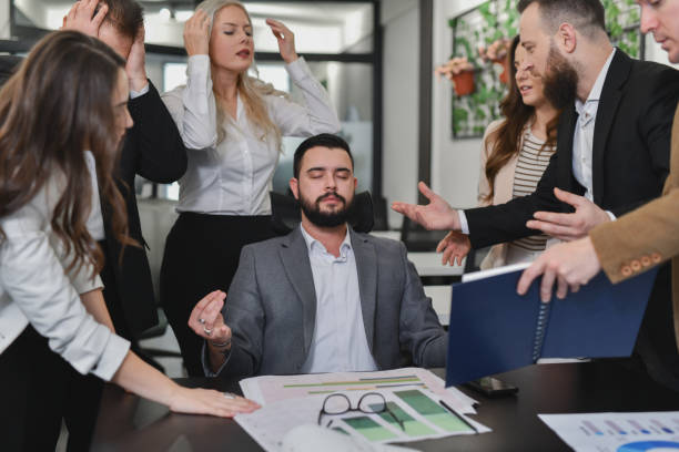 istock Frustrated Employees Looking For Answers From Manager While He's Meditating With Closed Eyes 2195059044