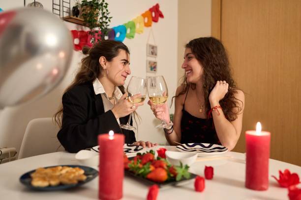 istock Lesbian couple celebrating valentine's day with romantic dinner 2195060141