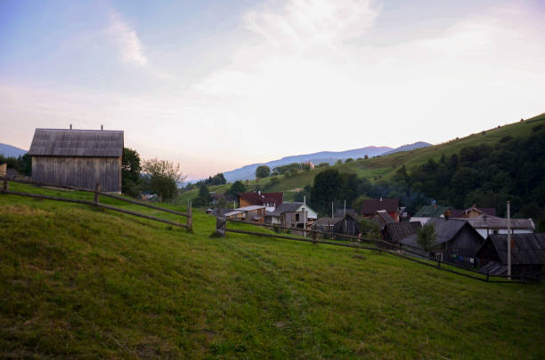Quiet rural village at sunset with mountains in the background