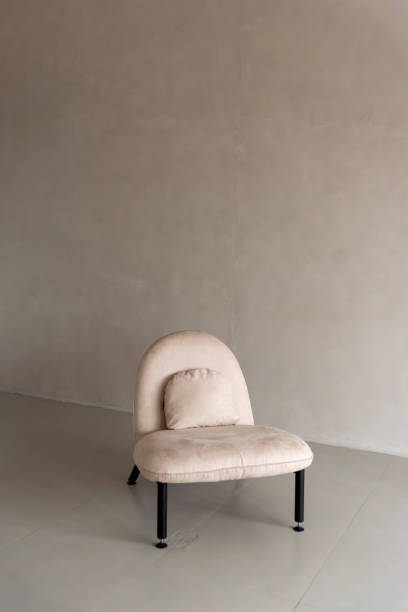 istock Soft beige chair without armrests in a bright room 2195060605