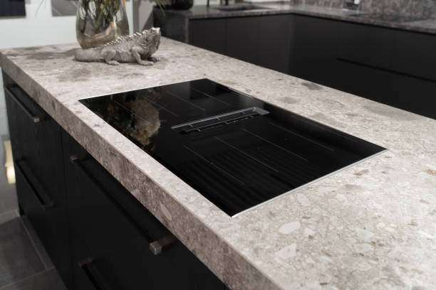 istock Induction cooktop hob with built in extractor hood on stone countertop 2195061688