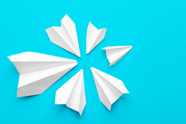 istock white paper airplane on a blue background 2195061991