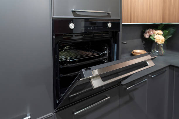 istock Modern black opened built-in oven in gray kitchen cabinet 2195062351
