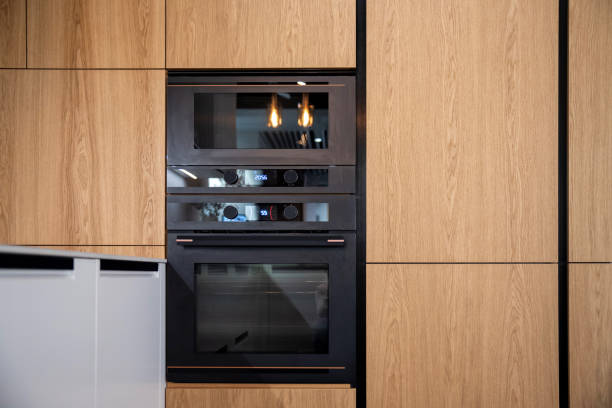 istock Modern kitchen with built-in oven and microwave in wooden cabinets 2195062359