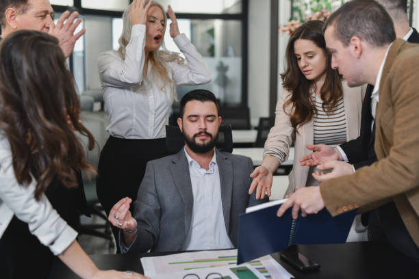 istock Employees Looking Angry and Frustrated When CEO Is Ignoring Them While Talking and Is Trying to Meditate 2195062638
