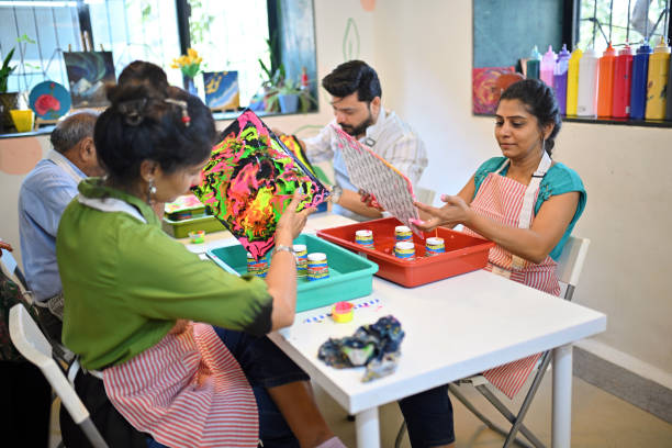 istock Creative fluid art workshop at an art studio with diverse adult participants engaged in colorful activities 2195065407