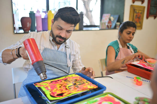 istock Engaging artists create vibrant fluid art paintings during a workshop at an art studio in a creative atmosphere 2195065415